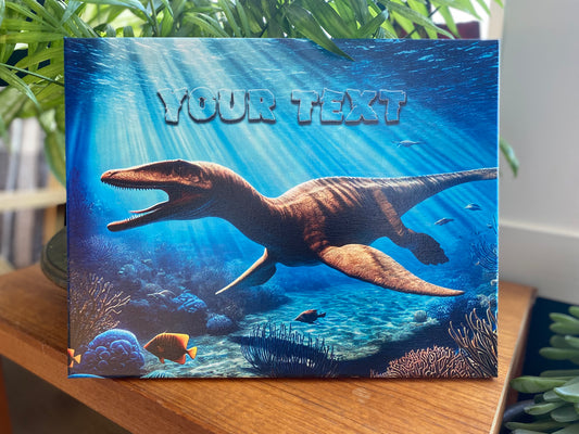 Vivid underwater scene of a plesiosaur swimming with its mouth open, revealing tiny sharp teeth. Sun rays penetrate the water, illuminating the dinosaur and the ocean floor. Small fish swim nearby, adding to the prehistoric marine atmosphere. Above the plesiosaur, 'YOUR TEXT' appears in a color scheme that blends seamlessly with the water’s texture and hues.