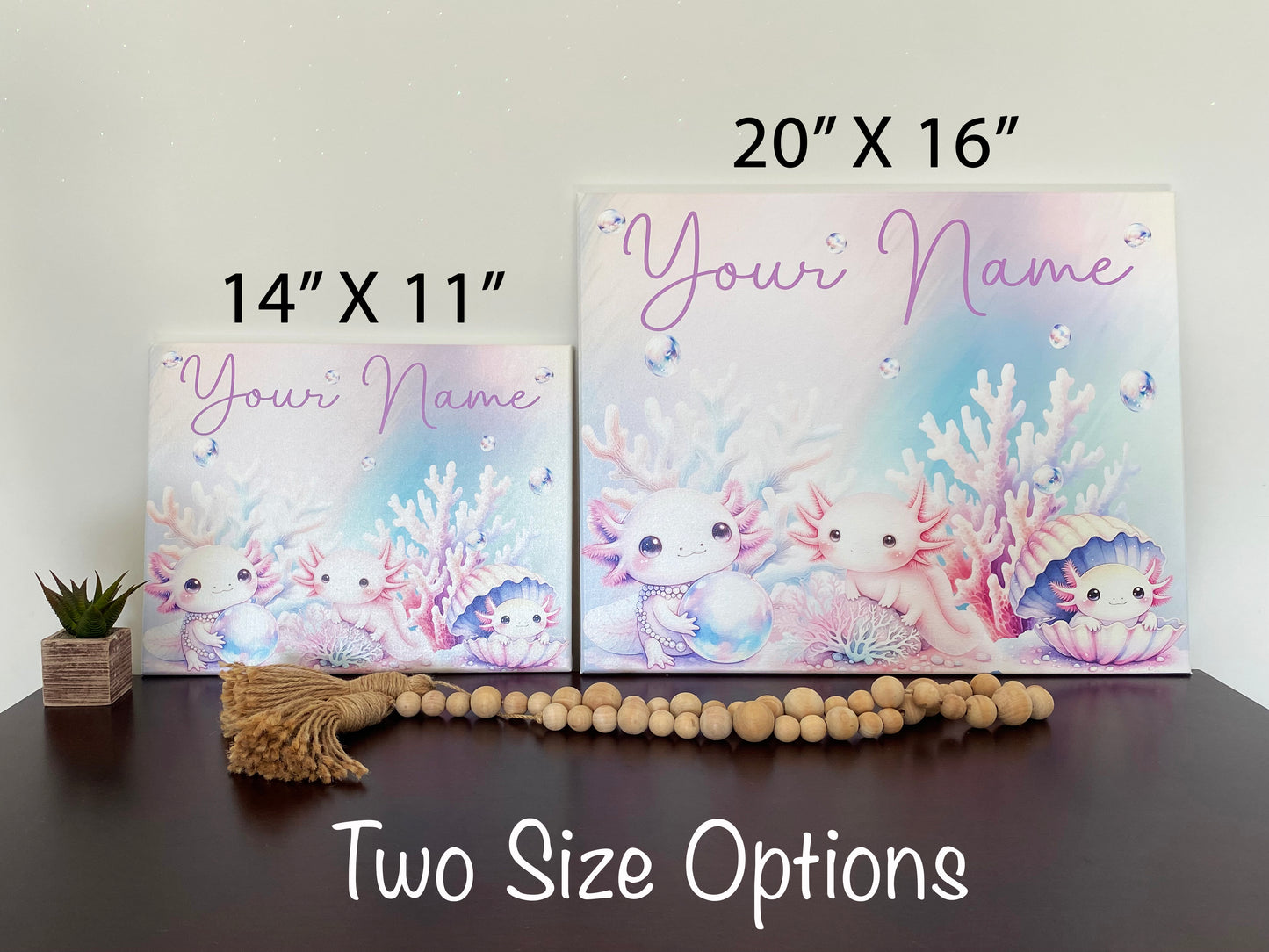 Personalized pastel canvas featuring your name  in a playful purple font, surrounded by an enchanting underwater scene. Three adorable, pink axolotls with expressive eyes are depicted among soft-hued coral, shimmering bubbles, and a pearl-filled seashell. The dreamy watercolor-style artwork creates a whimsical oceanic theme, perfect for kids' room decor, nursery art, or a unique custom gift.  Two different sized canvas are depicted 14x11 inch and 20x16 inch
